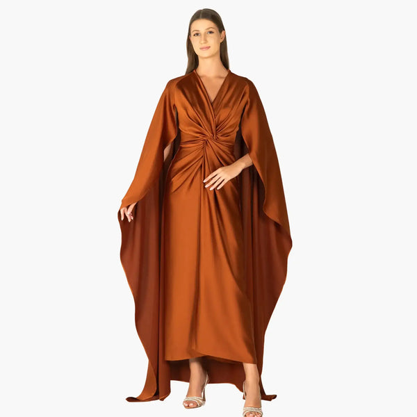 Bronzite Dress showcasing luxurious copper crepe fabric with draped bust and elegant cape for high-end fashion evening wear.