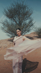 Model wearing the Meghan Dress from the Zarina Collection, showcasing luxury evening wear in soft Pink Quartz.