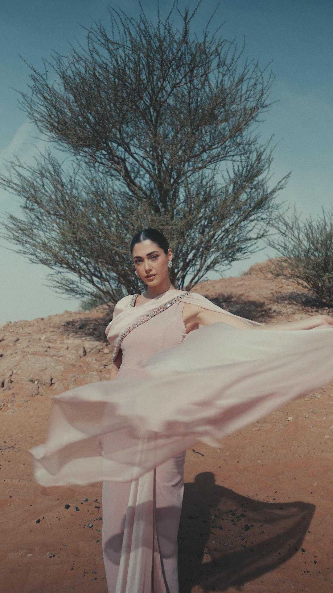 Model wearing the Meghan Dress from the Zarina Collection, showcasing luxury evening wear in soft Pink Quartz.