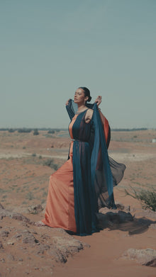 Irene Set featuring a model in a flowing navy blue and tangerine maxi dress, perfect for luxury evening wear.