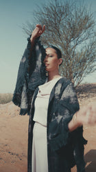 Layana Set in luxury fashion, showcasing women's clothing with pink quartz pantsuit against a desert backdrop.