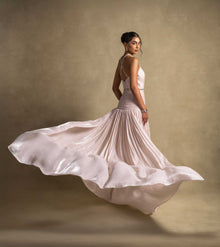 Avelisse Dress in beige, showcasing flowing pleats and an elegant design, perfect for high-end fashion and evening wear.