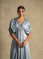 Cyra Dress showcasing a sage green gown with gathered bodice and soft volume sleeves, perfect for high end fashion and evening wear.