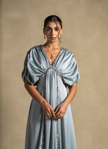 Cyra Dress showcasing a sage green gown with gathered bodice and soft volume sleeves, perfect for high end fashion and evening wear.