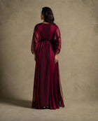 Burgaya Dress back view featuring a maroon chiffon gown with sheer sleeves, perfect for evening wear and luxury events.