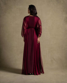 Burgaya Dress back view featuring a maroon chiffon gown with sheer sleeves, perfect for evening wear and luxury events.