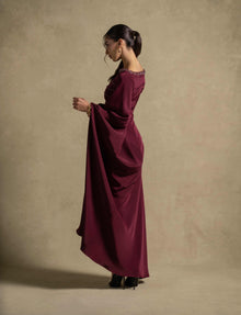 Roxana Dress side view in maroon, showcasing elegant draped detailing and embellished neckline, perfect for evening wear.
