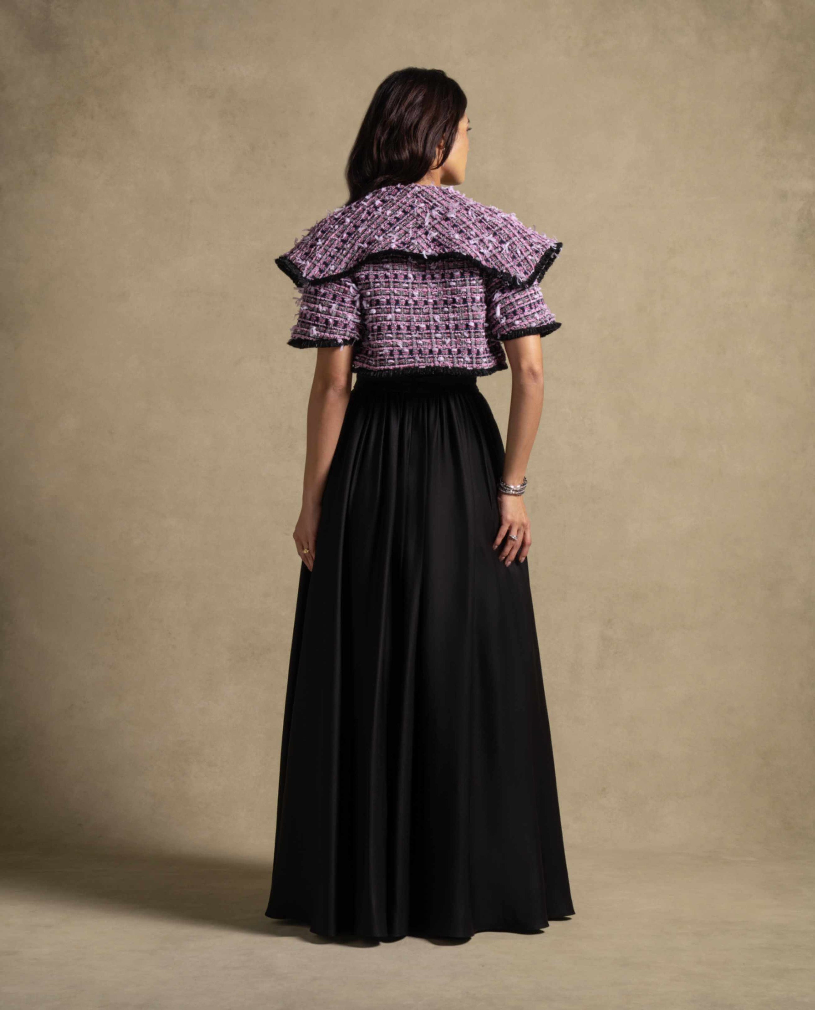 Zyra Set back view featuring a black maxi dress and structured tweed jacket, highlighting luxury evening wear fashion.
