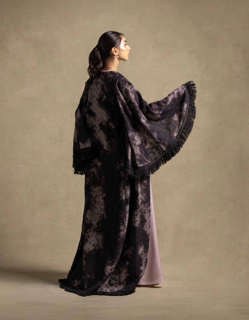 Elegant woman showcasing the Layana Set, a luxurious fringed outer layer from high end fashion collection.