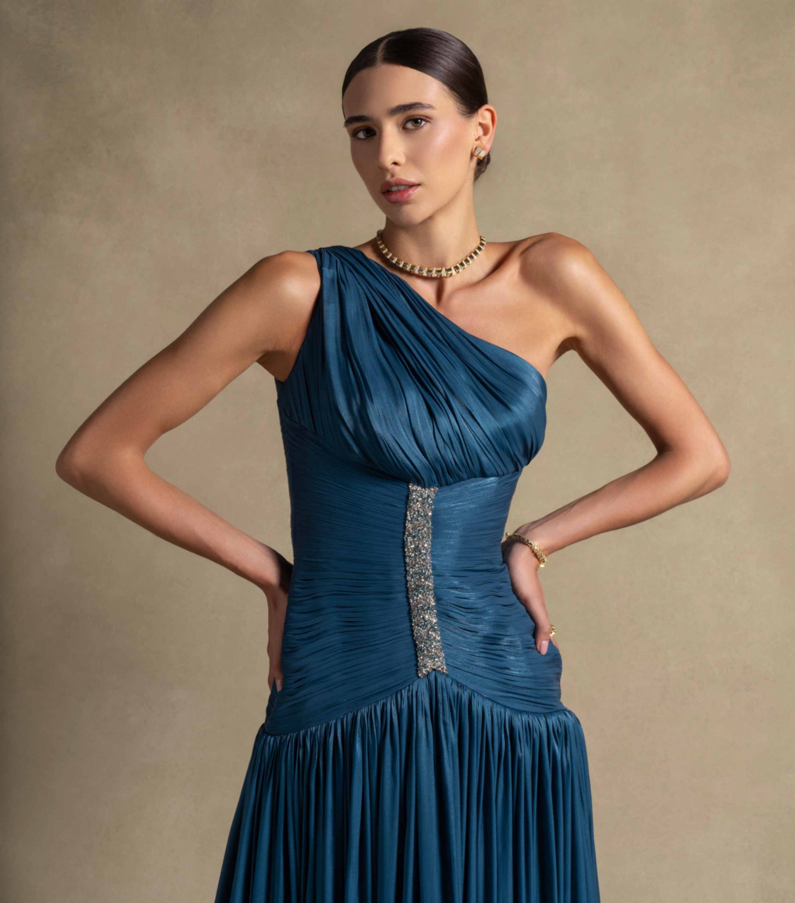 Layali Dress features a one-shoulder design with ruched bodice and embellishments, perfect for luxury evening wear.