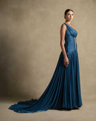 Layali Dress showcased in turquoise with one-shoulder design and flowing skirt, perfect for evening wear and luxury occasions.