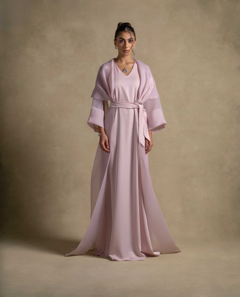 Isis Set showcasing a luxurious pink quartz maxi dress with a belted waist and sheer organza overlay, perfect for evening wear.