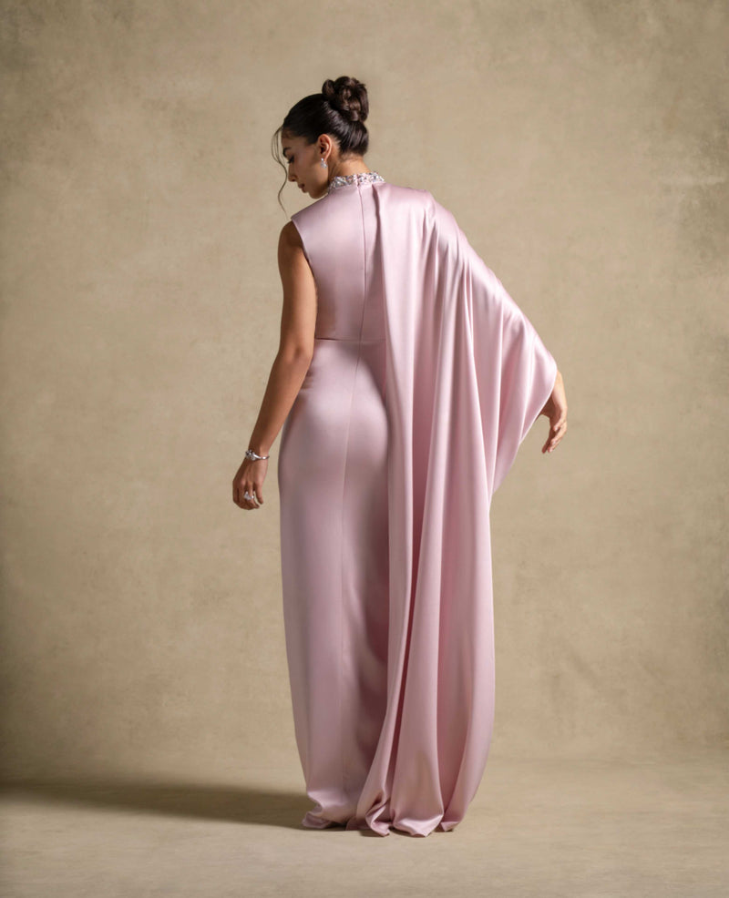 Back view of Aaliyah Dress, a luxury pink gown with a draped cape, perfect for evening wear and high end fashion.