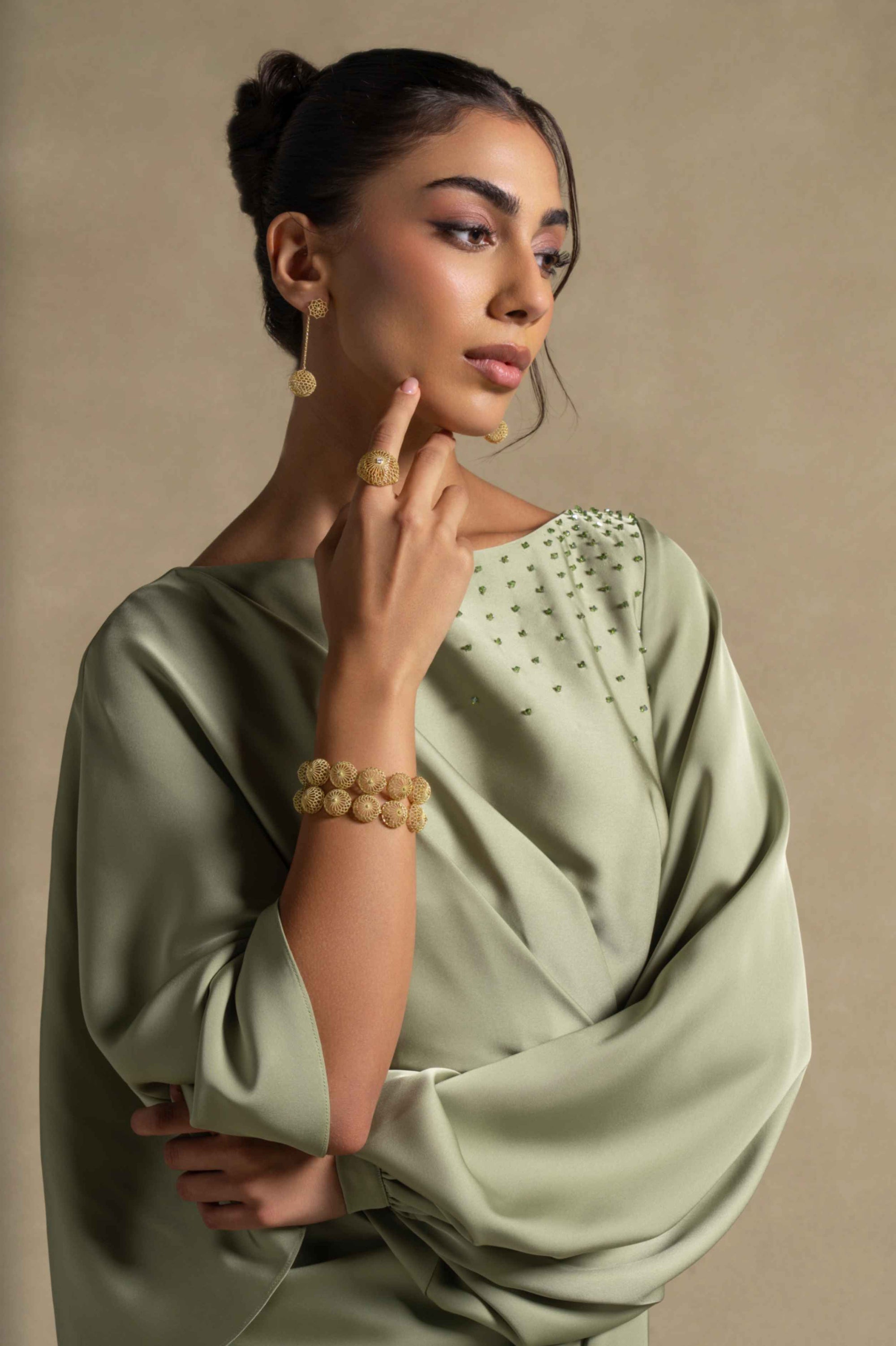 Renee Dress in pistachio green with draped sleeves and embellished neckline, ideal for luxury evening wear.