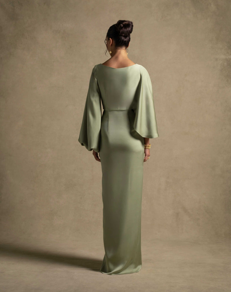 Renee Dress in pistachio color showcasing draped waist and long sleeves, perfect for luxury evening wear.
