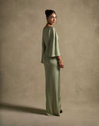 Renee Dress in pistachio color, showcasing luxury evening wear with draped sleeves and an elegant silhouette.