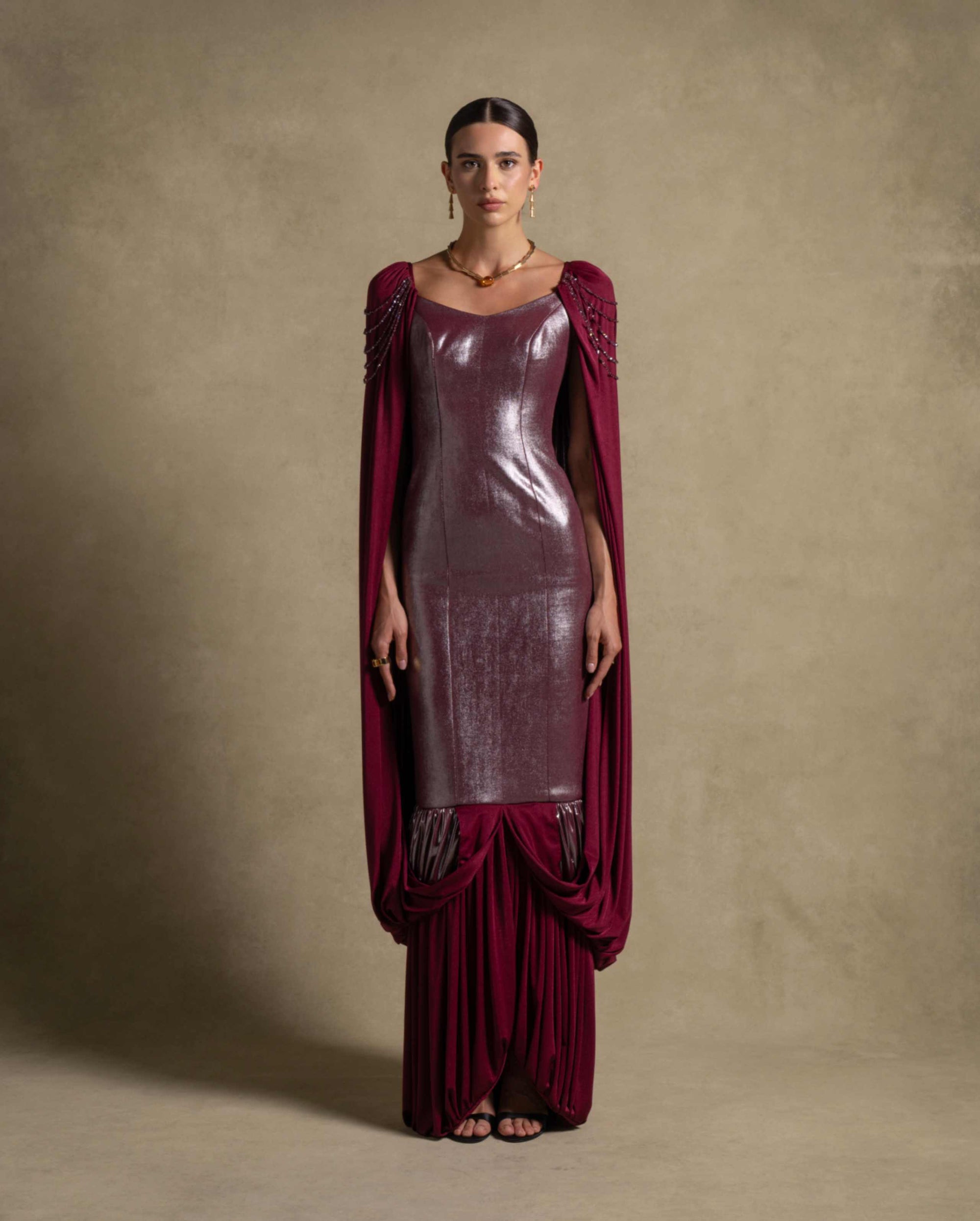 Vionna Dress in deep maroon with a metallic finish bodice and draped jersey panels, perfect for luxury evening wear.