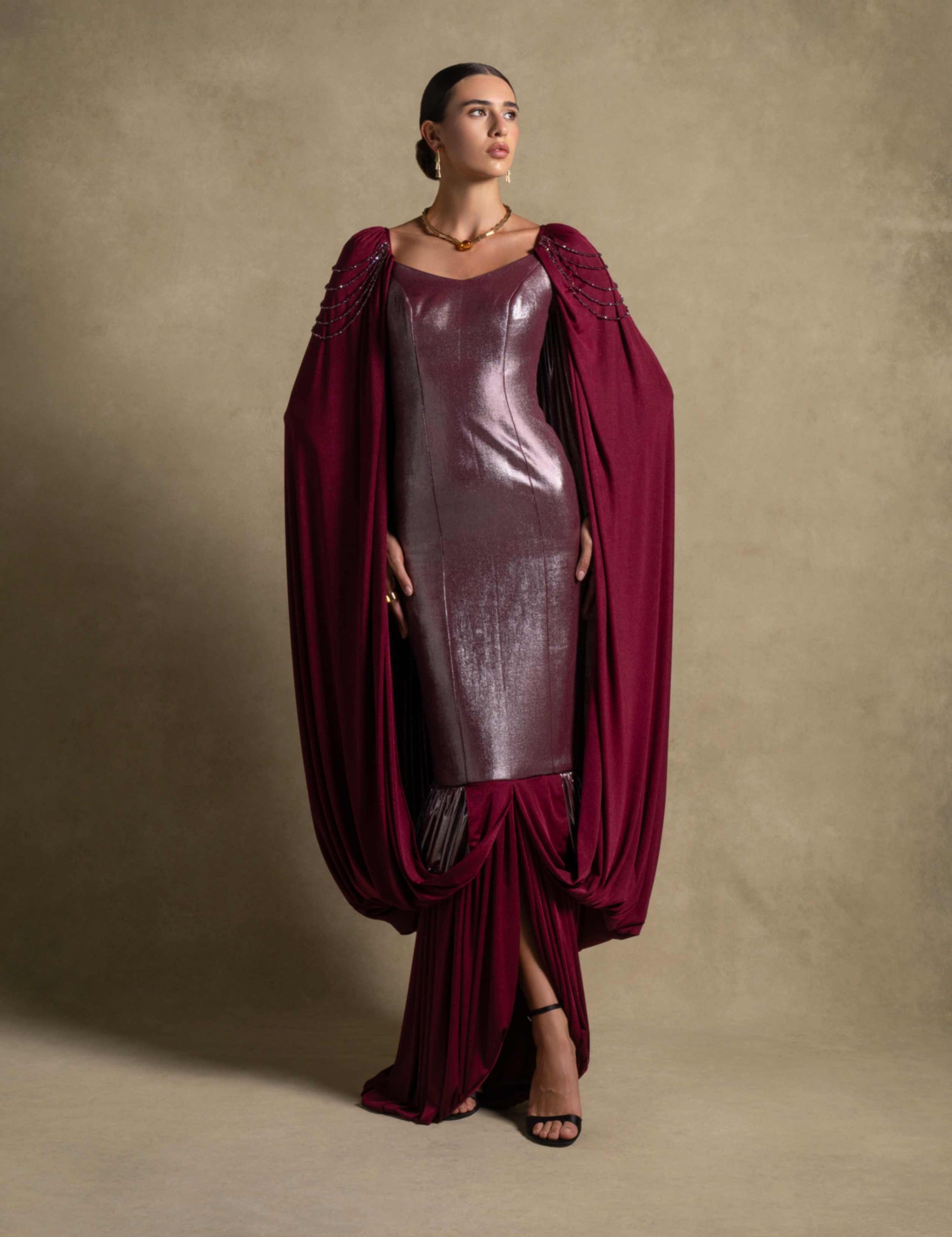 Vionna Dress in deep Maroon with metallic bodice and draped panels, epitomizing luxury evening wear.