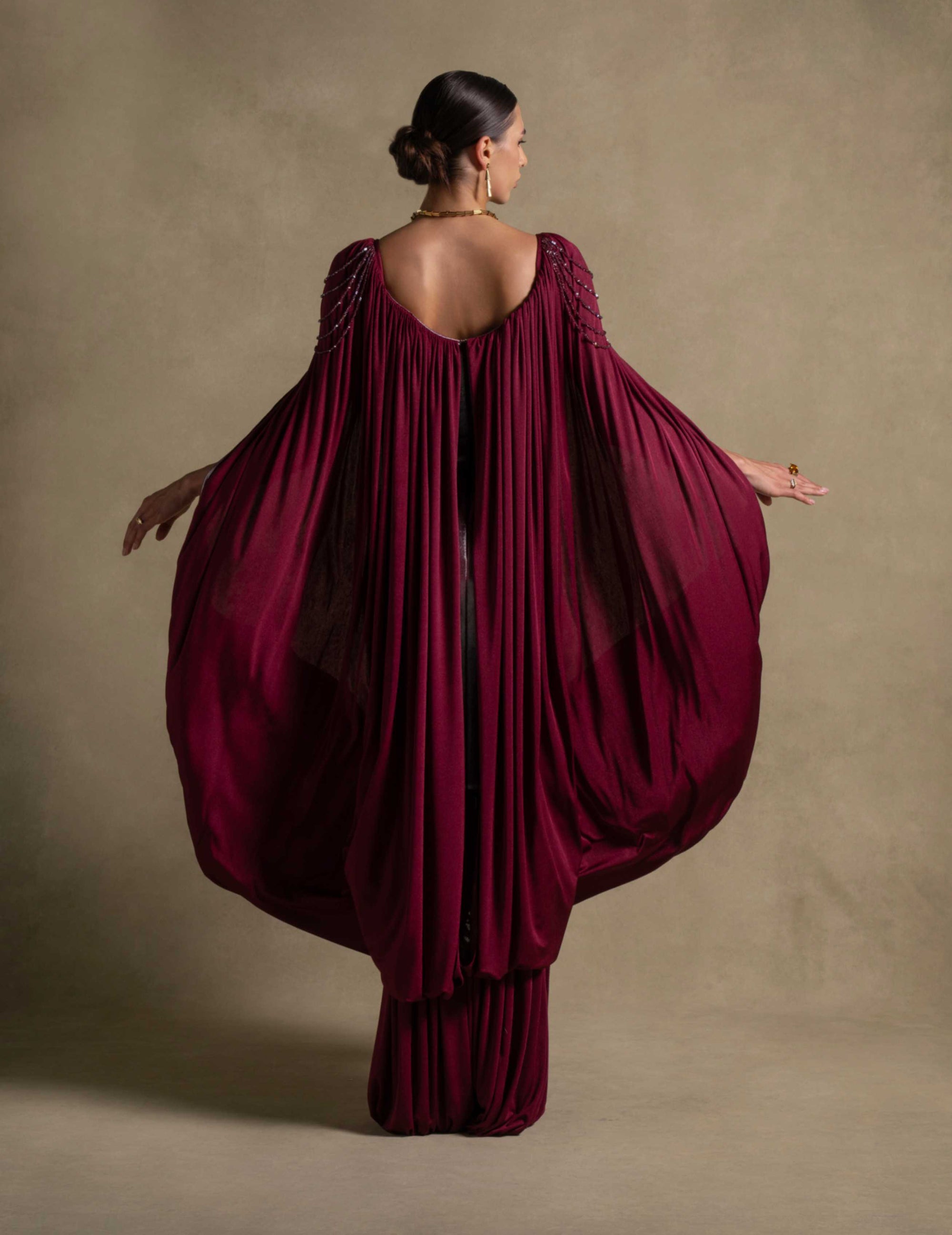 Vionna Dress in deep maroon showcasing sculpted bodice and draped jersey, perfect for luxury evening wear.