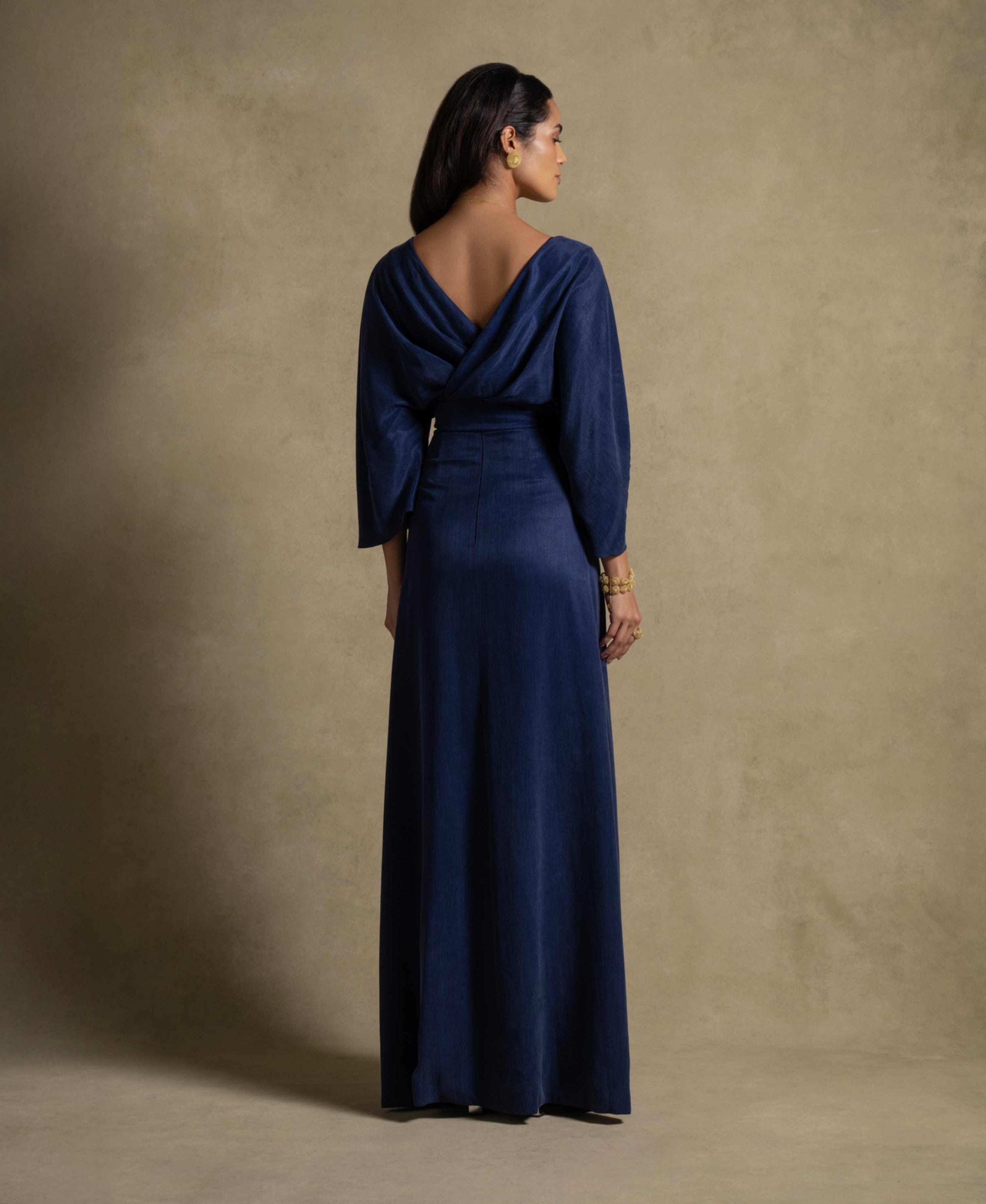 Back view of the Palatino Set, a luxury denim blue maxi dress from the Zarina Collection, showcasing elegant evening wear.