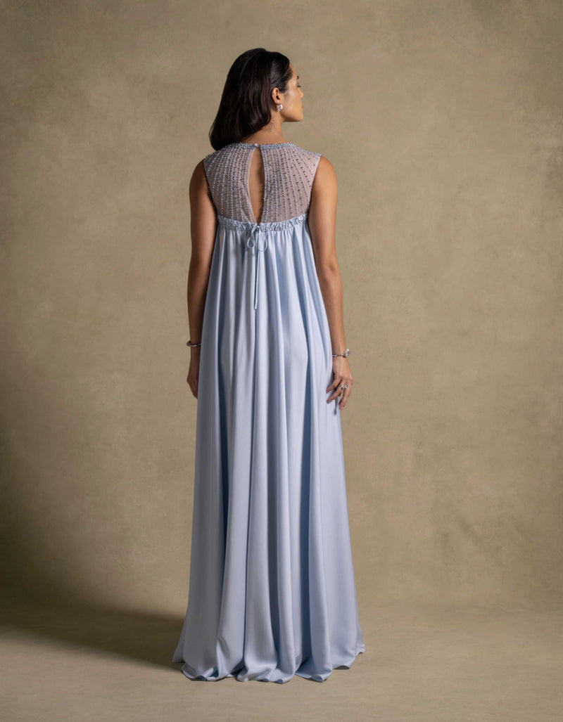 Noor Dress in baby blue from the Zarina Collection, showcasing a graceful silhouette and sheer embroidered neckline.