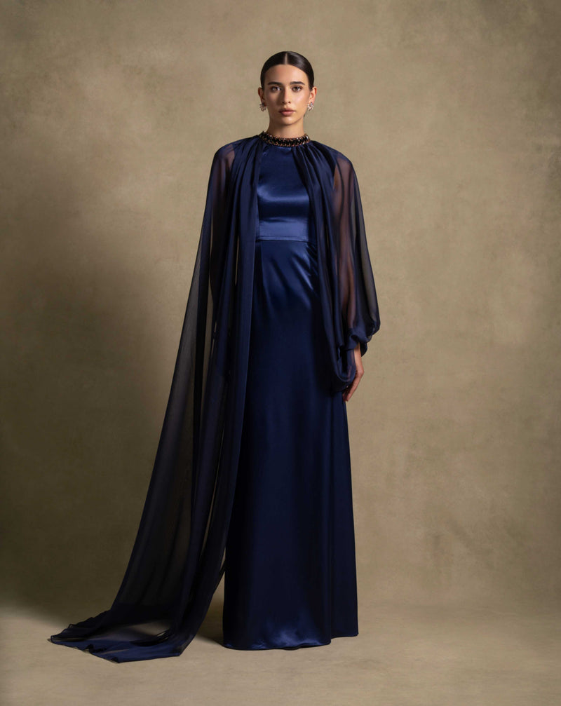 Daryan Dress in royal blue, featuring a sleek satin gown with a chiffon cape, ideal for evening wear and high-end fashion.